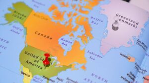 Map showing Greenland, Canada, and the United States with pins marking Greenland and the US.